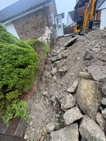 Excavation works removing thick concrete driveway and existing steps.